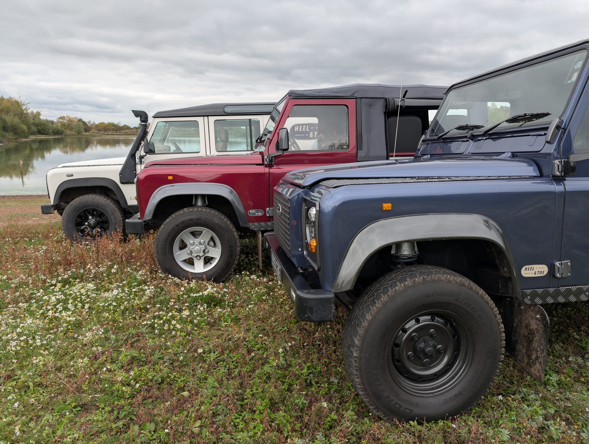 three land rover defenders
